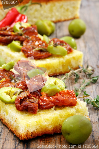 Image of Bread with olive oil with sun-dried tomatoes and thyme. 