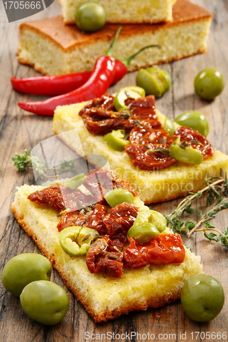 Image of Appetizer of sun-dried tomatoes, olives and thyme.