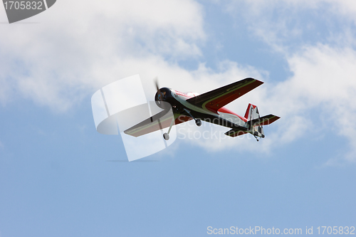 Image of RC model airplane flying in the blue sky