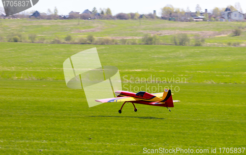 Image of RC model airplane lands on the grass