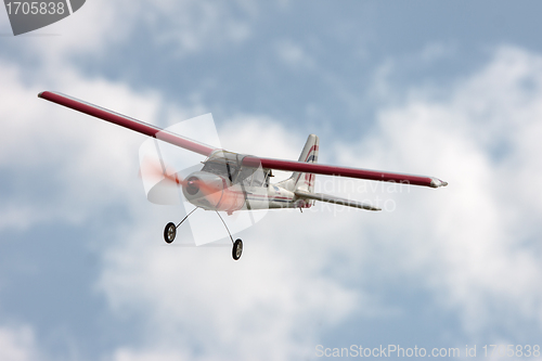 Image of RC model airplane flying in the blue sky