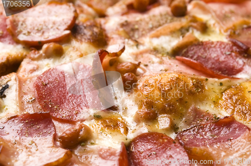 Image of Italian pizza with bacon, salami and mozzarella cheese