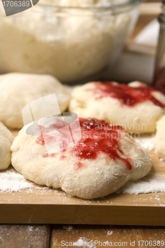 Image of Dough with marmelade on wooden board