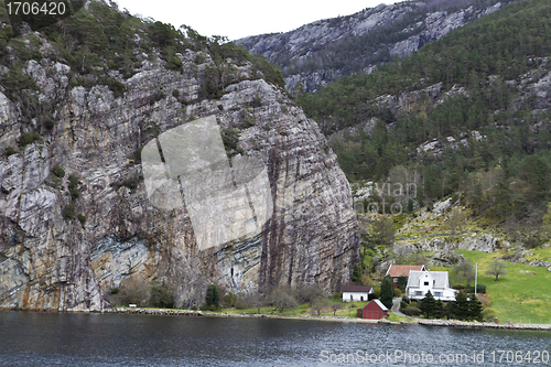 Image of some houses under big rock