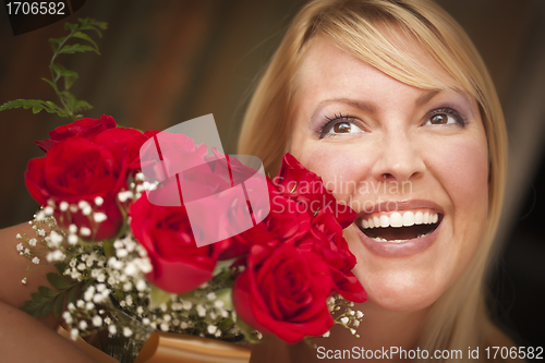 Image of Smiling Blonde Woman with Red Roses