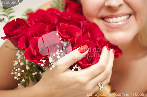 Image of Smiling Woman Holding Bunch of Red Roses