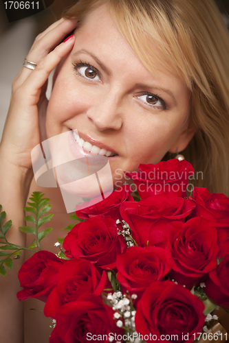 Image of Smiling Blonde Woman with Red Roses