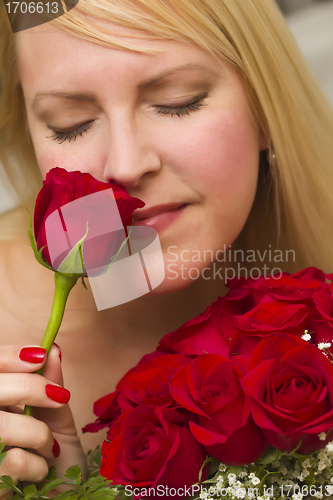 Image of Woman Smelling a Bunch of Red Roses