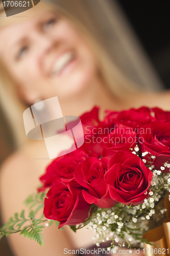 Image of Blonde Woman Accepts Gift of Red Roses