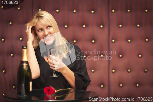 Image of Sensual Blonde Woman Sitting Near Champagne and Rose