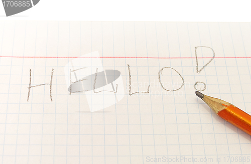 Image of Text Hello word written by pencil on notebook sheet
