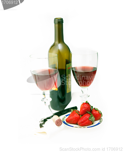 Image of red wine bottle and two glasses with strawberries