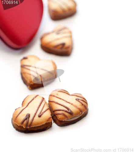 Image of heart shaped cream cookies on red heart metal box