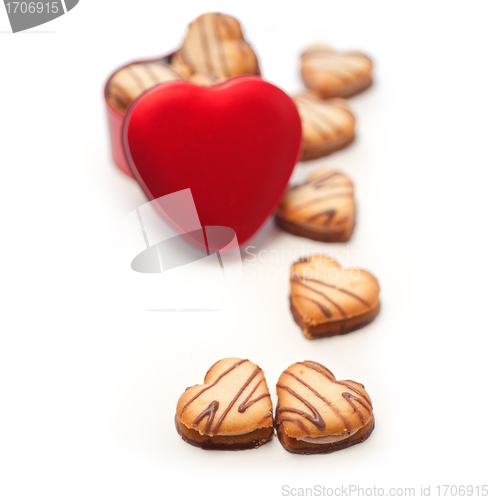 Image of heart shaped cream cookies on red heart metal box