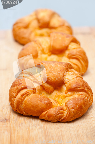 Image of fresh baked french croissant brioche on wood board