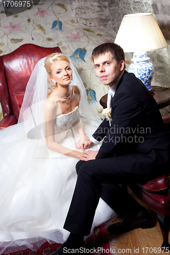 Image of beautiful groom and bride in interior