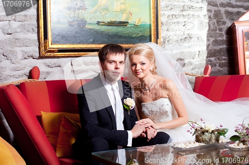 Image of beautiful groom and bride in interior