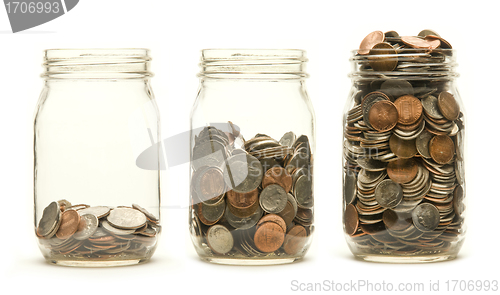 Image of Three glass jars holding coins