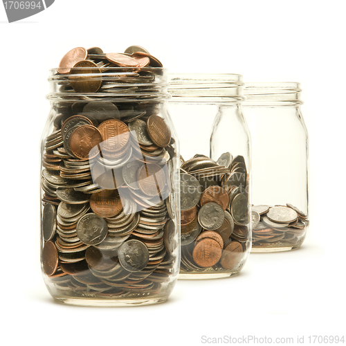 Image of Three glass jars filled with American coins