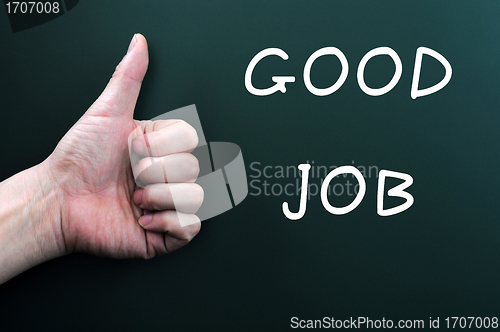 Image of Thumb up with good job written on a blackboard