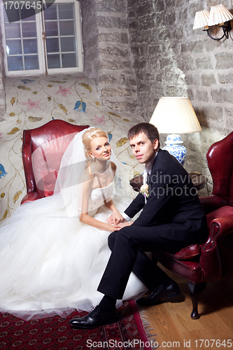 Image of beautiful groom and bride in interior