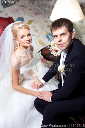 Image of beautiful groom and bride in interior