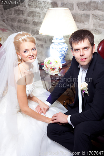 Image of beautiful groom and bride in interior
