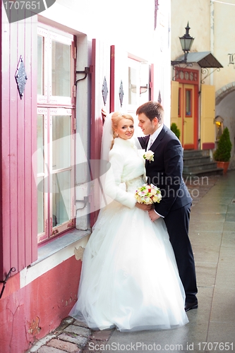 Image of beautiful groom and the bride on the street of old town