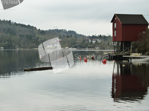 Image of small building on stilts on coastline in norway