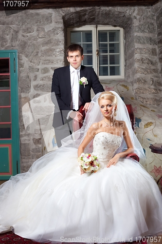 Image of beautiful groom and bride in interior