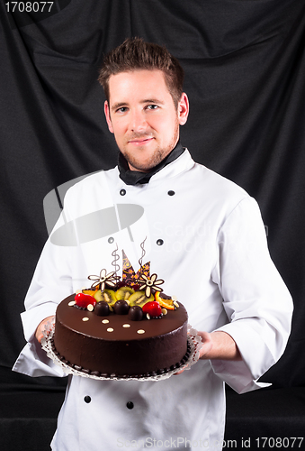 Image of Handsome chef with cake