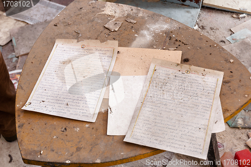 Image of Old documents on dirty table