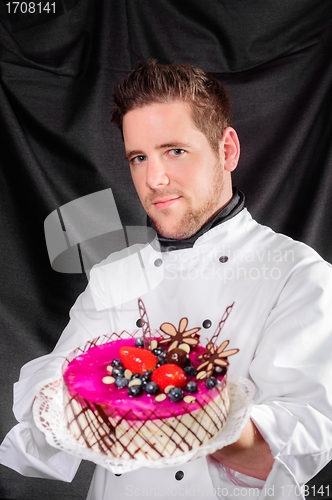 Image of Handsome confectioner with cake 