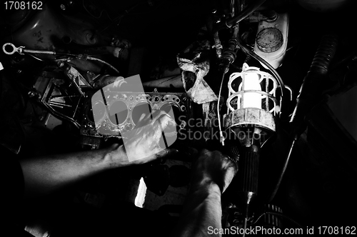 Image of Hands of a worker repairing car