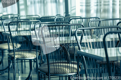 Image of Photo of a canteen with metal chairs and tables