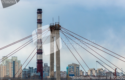 Image of Big industrial chimney in the middle of a city