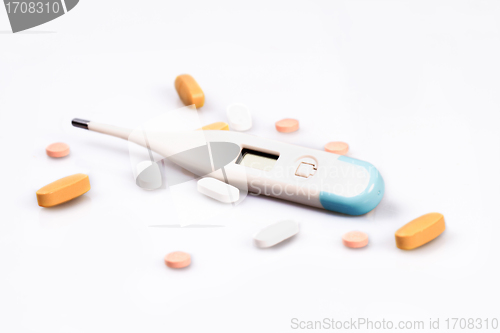 Image of Thermometer and pills isolated on white