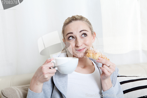 Image of beautiful woman relaxing on couch with cup of coffe 