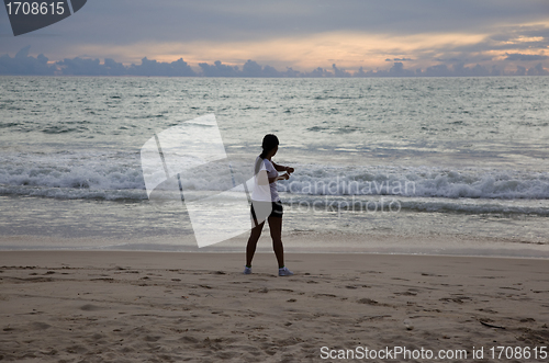 Image of Thai girl doing gymnastics on the beach