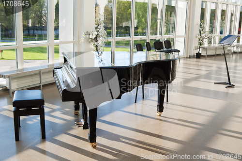 Image of Grand piano in the hall shined by the sun