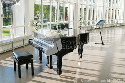 Image of Grand piano in the hall shined by the sun
