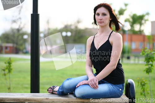 Image of girl is posing against park