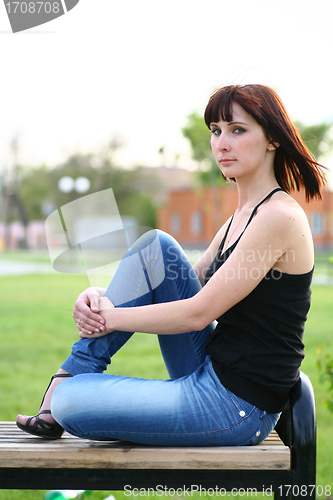 Image of girl is posing against park