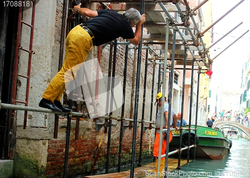 Image of builders repair a house in Venice