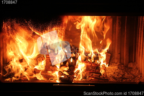 Image of burning wood in a fireplace