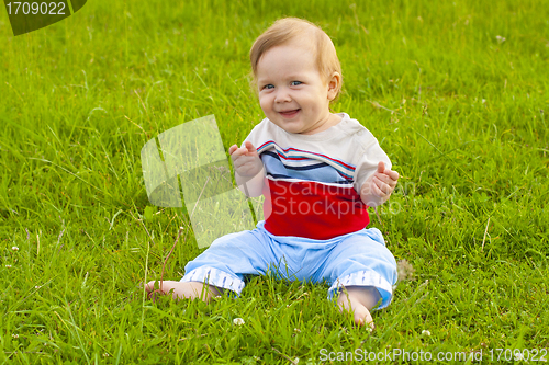 Image of baby sitting on grass