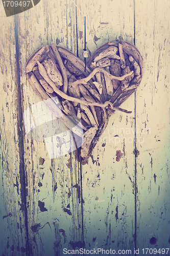 Image of driftwood heart on vintage wall