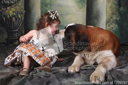 Image of Adorable Child and Her Saint Bernard Puppy Dog