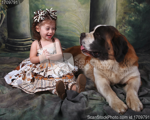 Image of Adorable Child and Her Saint Bernard Puppy Dog