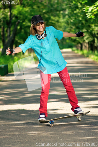 Image of Teenage girl with skateboard